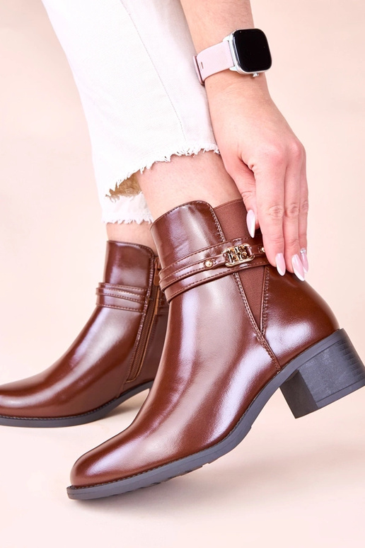 Hnedé čižmy na stĺpiku s dekoratívnym...